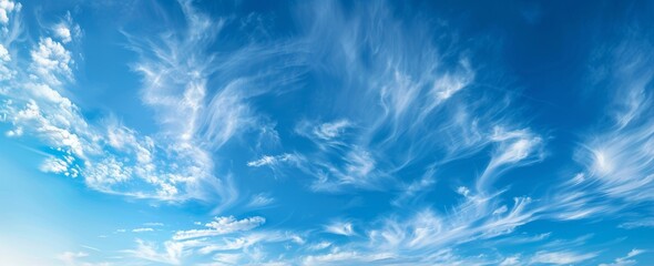 Obraz premium Clear Blue Sky Background with Clouds for Elegant and Clean Design, Perfect for Banners and Website Use