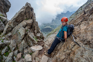 Woman climbing in the mountains.