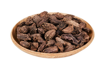 closeup pile of Amomum subulatum or black cardamom isolated on white background in wood bowl