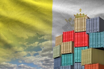 Vatican City State flag and big stack of shipping cargo containers in docks with sky background close up