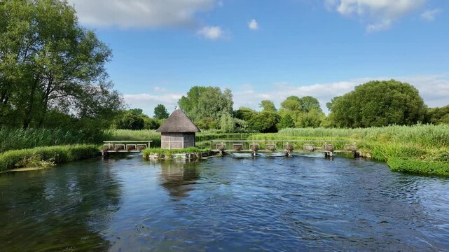 Longstock Stockbridge England. 17.07.2024. River Test flowing through the Hampshire countryside UK