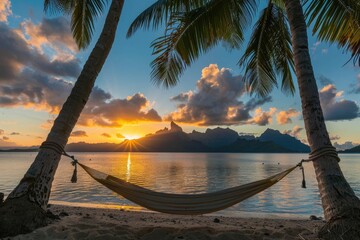 A hammock strung between two palm trees on the beach of an island in french polynesia, with clear blue water and sunset in background, with overwater b constructive behind the horizon,