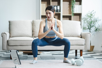 Obraz premium Asian healthy woman workout at home, exercise, fit, doing yoga, home fitness concept.