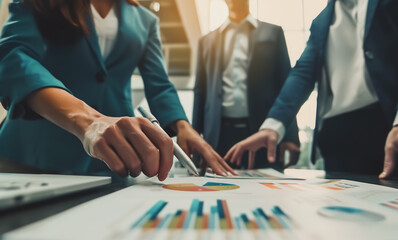 Professional business team working on a project together in the office Using economic growth charts and network connections to accompany the data. in analyzing future trends
