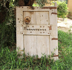 Old door made of wood with copper knocker
