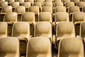 Empty stands and seats for fans and fans in the open-air stadium. Lack of fans during the pandemic.. Beautiful simple AI generated image in 4K, unique.