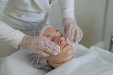 Cosmetologist prepares skin for a procedure, ensuring optimal treatment conditions.