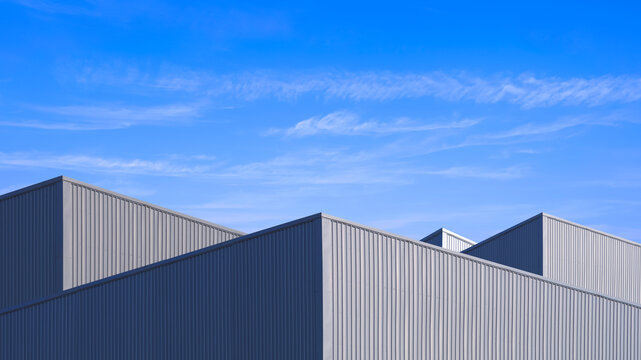 Geometric industrial factory buildings with sunlight and shadow on surface of gray aluminium corrugated steel wall against blue sky background in minimal style, low angle and perspective side view