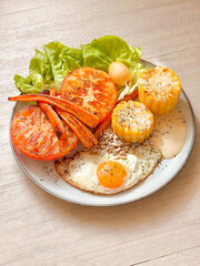 Breakfast dish with sunny side up egg, tomato, corn, and carrot. Delicious food. Cooking recipes. Healthy recipe. Healthy meal. Bruch menu. Diet food. Easy home cooking. Happy holidays. American. 