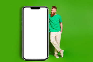 Full length photo of positive dreamy man dressed t-shirt texting instagram twitter telegram...