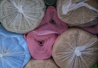 Close up of stacked blue and pink mats with vinyl for sale at Dongmyo Flea Market of Sungin-dong near Jongno-gu, Seoul, South Korea
