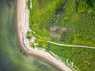 Small lighthouse in Traeskohage at the fjord in Vejle, Denmark