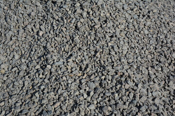 Gravel texured background. Pile of gray gravel background.