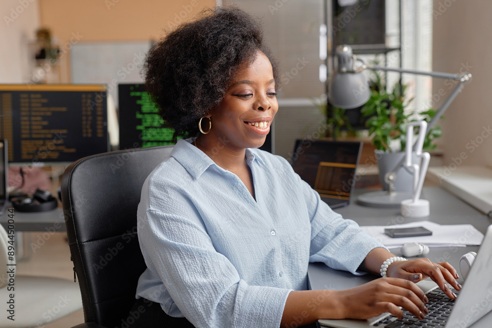 Poster medium portrait of young female african american computer programmer smiling typing on keyboard whil