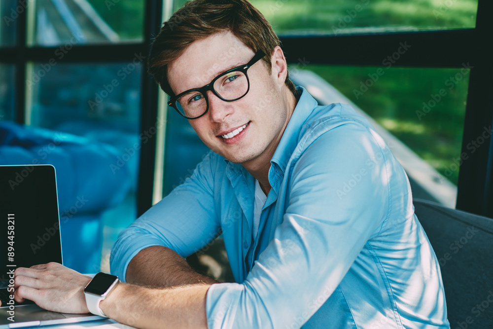 Poster portrait of successful student smiling at camera while collaborating together with young woman durin