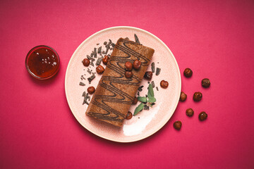 Cake roll in a bowl with jam and nuts