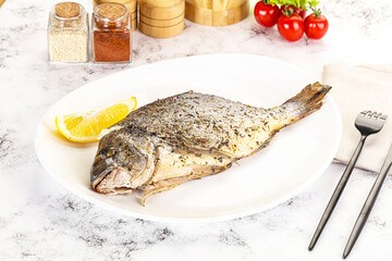 Baked Dorado fish served lemon