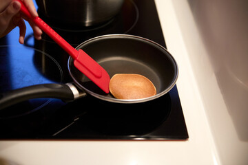 Flipping a pancake in a frying pan