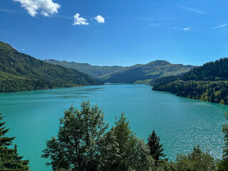 Naklejka premium Beautiful Lake Roselend with turquoise water, clouds and blue sky