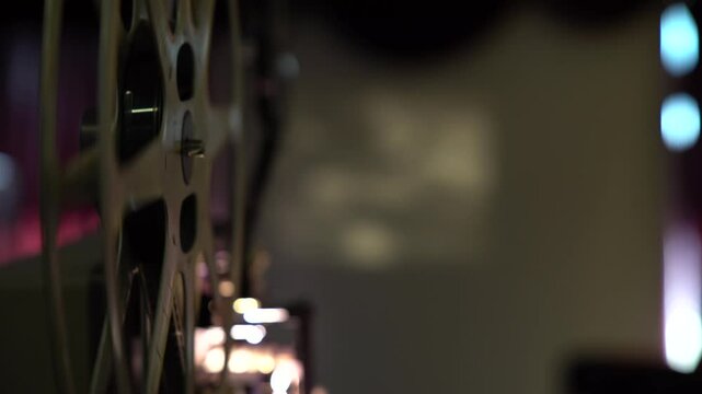 old film machine projects black and white film onto the screen