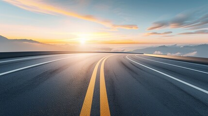 Naklejka premium A winding asphalt road leads into a scenic mountain landscape with a vibrant sunrise in the distance. Photo depicts a sense of open road and possibility.