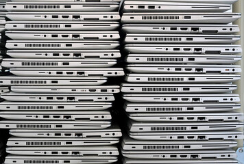 Big stacks of discarded laptops, notebooks on a trolley