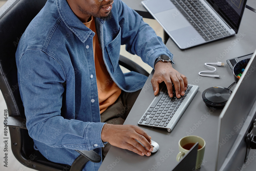 Poster high-angle cropped shot of male african american employee in it company typing on keyboard writing p