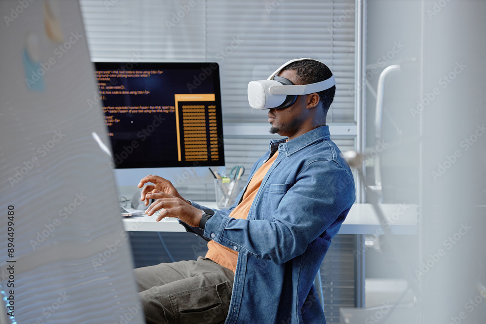 Poster side view shot of male african american software developer testing vr user experience wearing vr hea