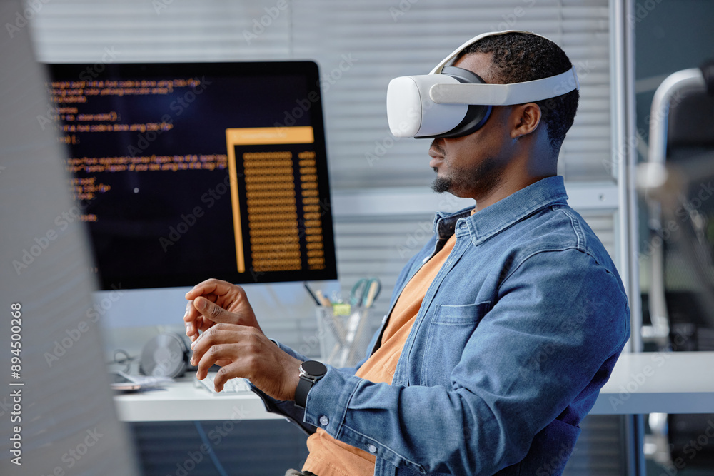 Poster side view shot of male african american software engineer testing vr application or video game weari