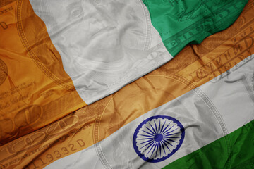 waving colorful flag of india and national flag of ivory coast on the dollar money background....
