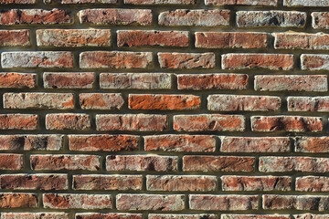 The old brick wall is damaged by time. A brick wall of a castle or an old house