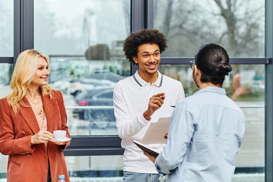 A group of hard-working job seekers talking in front of a window.