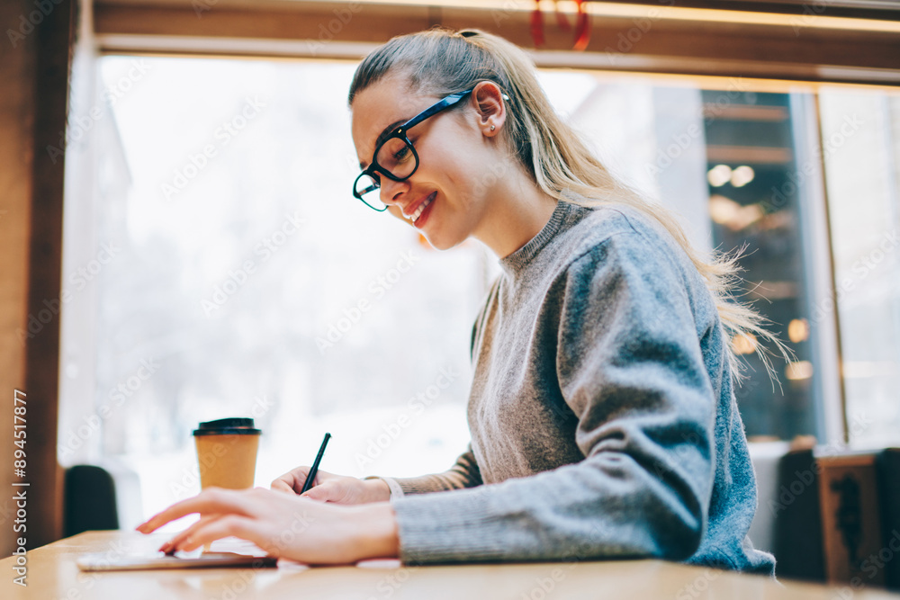 Poster happy female blogger using application on smartphone for typing new text messages and creating new p