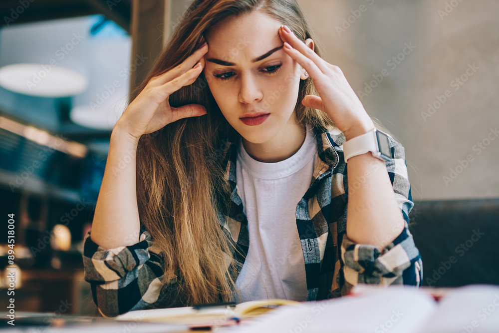 Poster stressed female student learning languages at university library using netbook and books, tired sad 