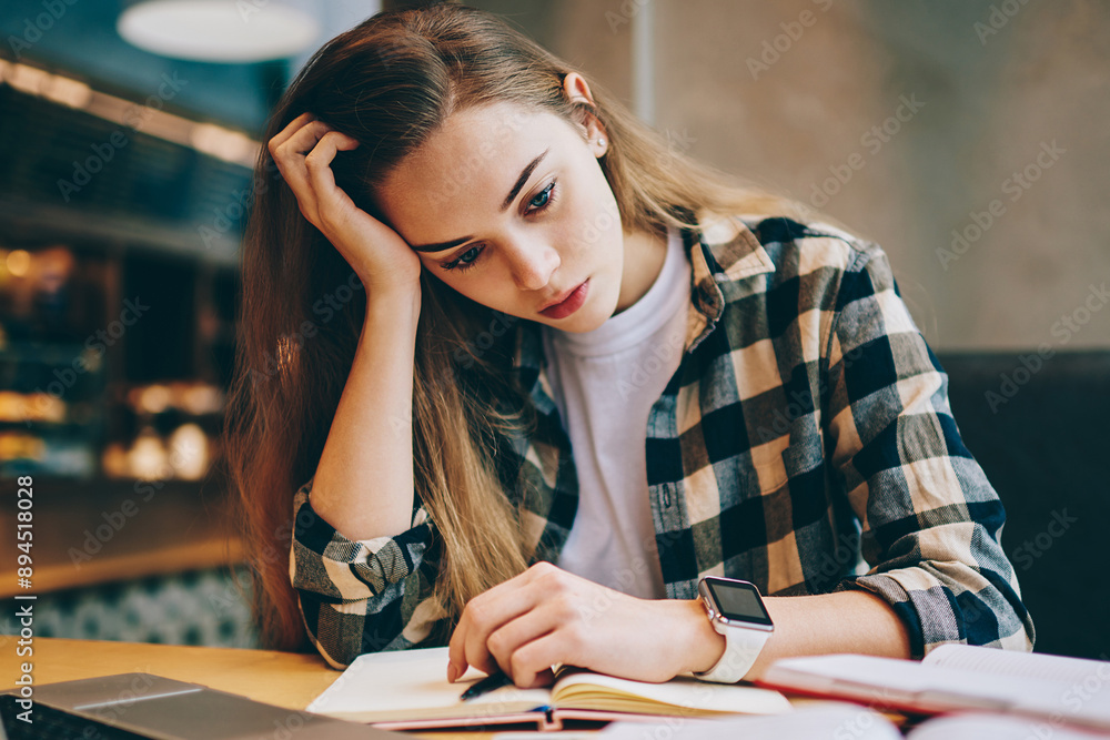 Poster tired female student preparing for important exam trying find answers for questions using modern lap