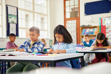 Elementary students studying in classroom during a test