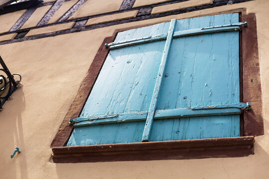 Teal Shuttered Windows on Pink Wall