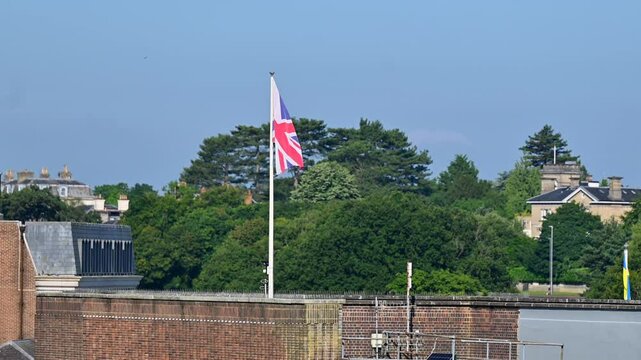 British Union Jack flag flying over a town in England
