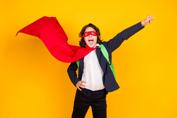 Photo portrait of little pupil boy flying superhero wear trendy uniform isolated on yellow color background