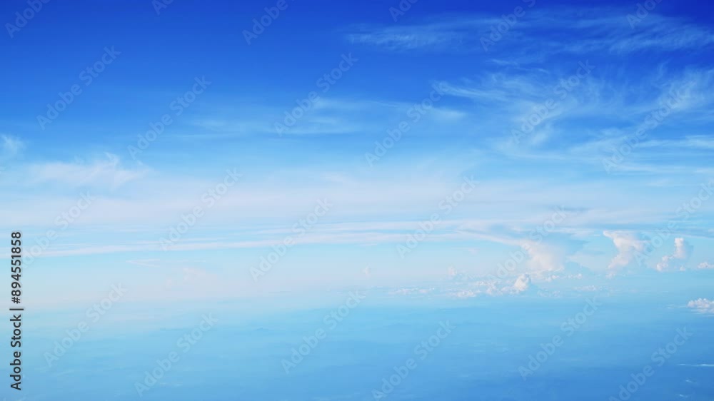 Wall mural aerial view of white clouds, from airplane window with blue sky