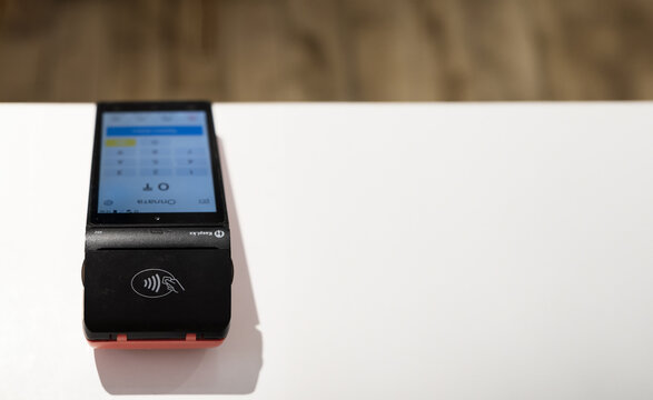 Uralsk, Kazakhstan - 27.02.24: Pos payment terminal device for reading banking cards in the cafe. Kaspi Bank