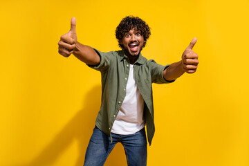 Portrait photo of young funny mexican guy in khaki shirt demonstrate high quality likes gesture...