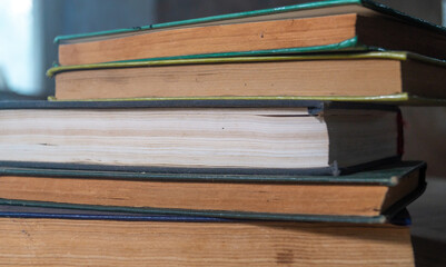 A column of books with yellowed pages. Close-up of a column of old books