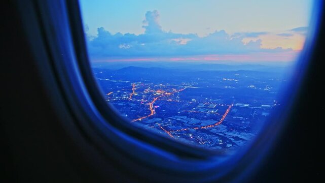 Aerial view of city through airplane window at night