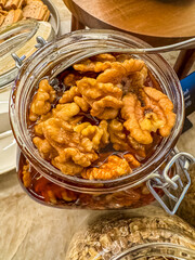 walnut with honey in glass jar with spoon . High quality photo