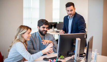 Business professionals collaborating on investments and teamwork, using a computer during a meeting, and working in partnership on the stock market.