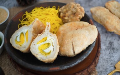 Pempek or mpek-mpek is a delicacy from Palembang, South Sumatra. It is made of fish and sago flours and served together with a dark, rich sauce called cuko.
