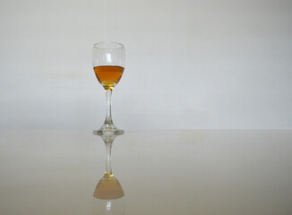 a glass of wine and its reflection on the table