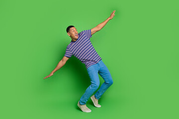 Photo of cheerful glad man wear stylish clothes look empty space isolated on green color background