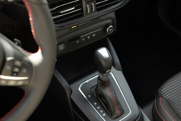 The interior of a car with a leather gear shifter